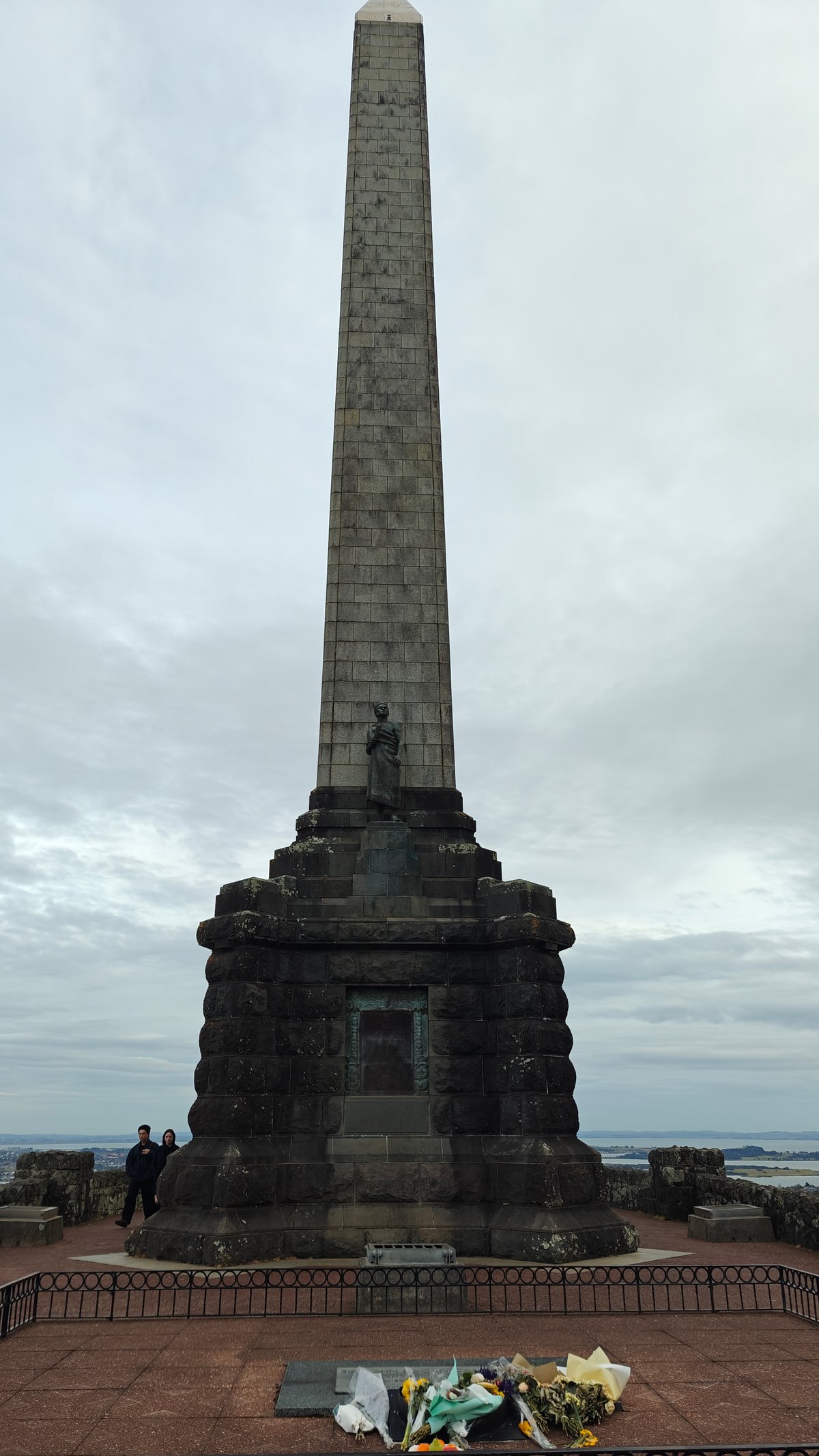 Obelisk and bronze Māori figure