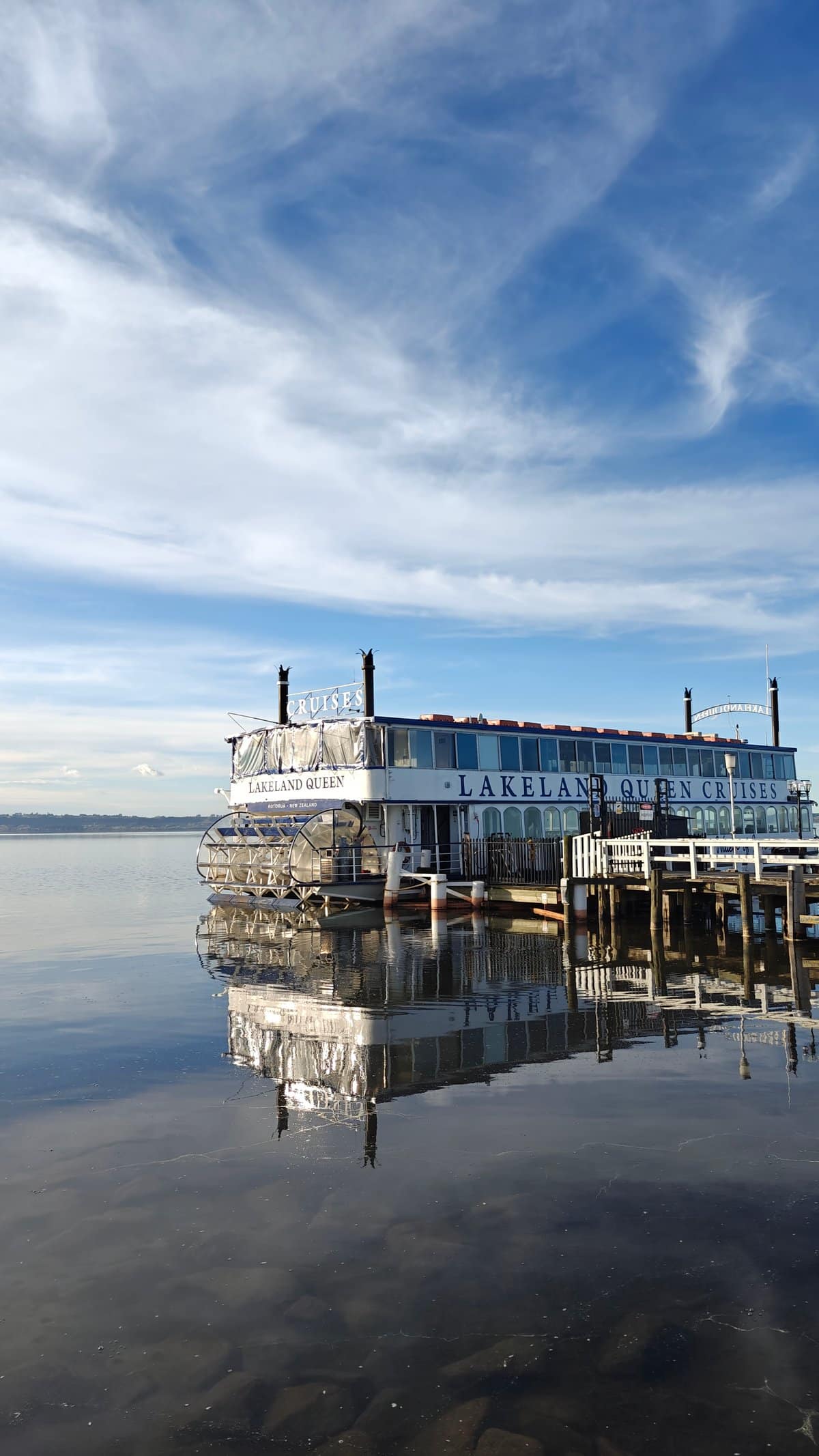 Paddle steamer reflection under cirrus