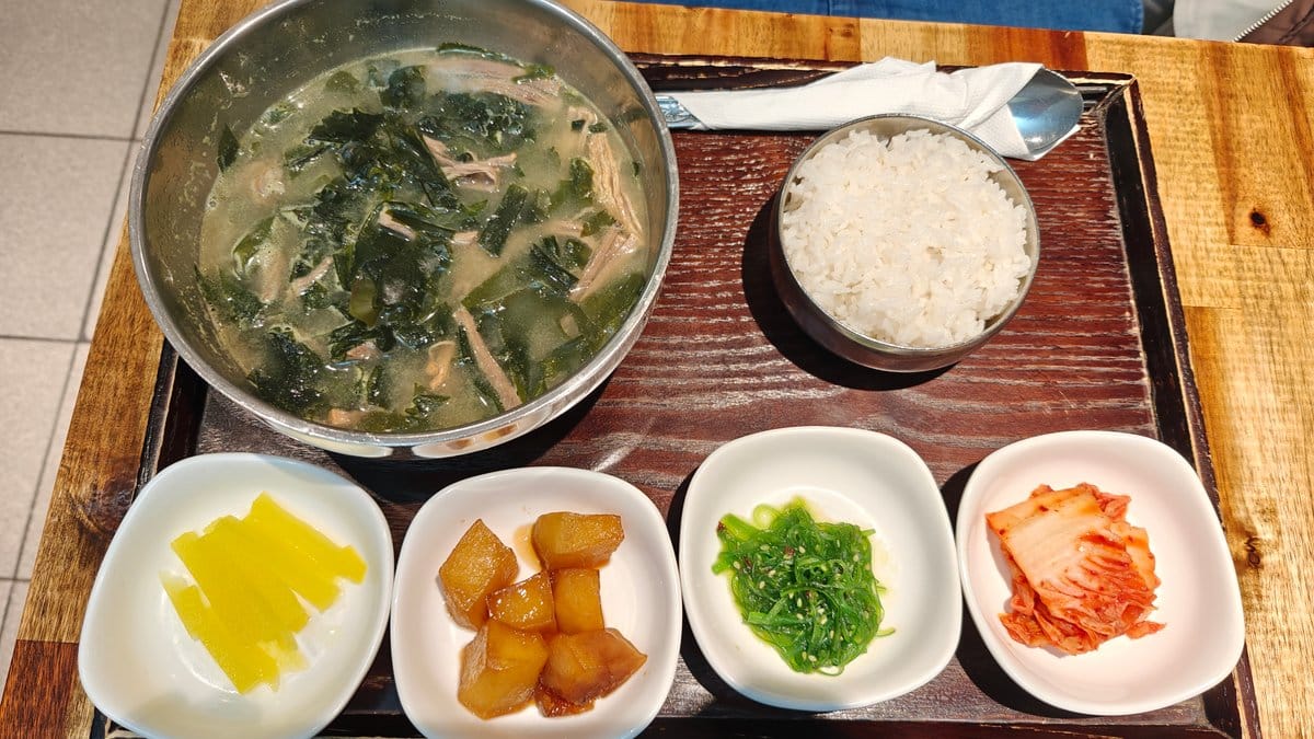 Pale broth soup served with rice