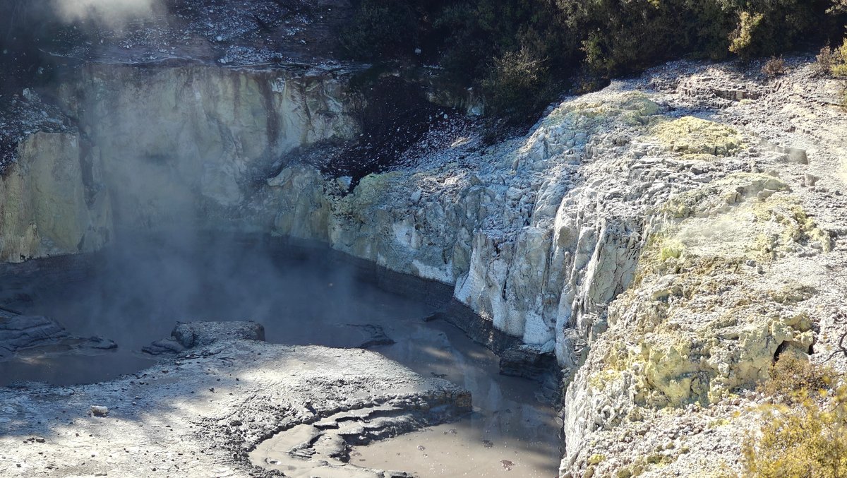 Pale cliffs and steaming water