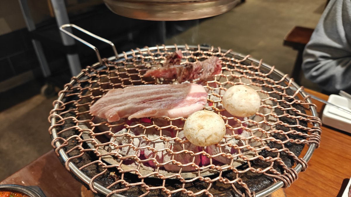 Pork belly sizzling on the charcoal grill