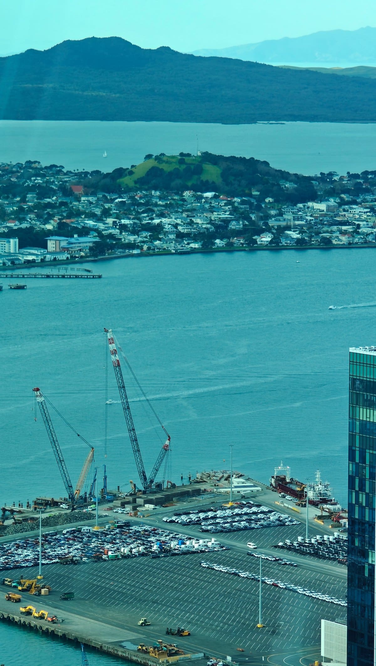 Rangitoto across the harbour with a crane working