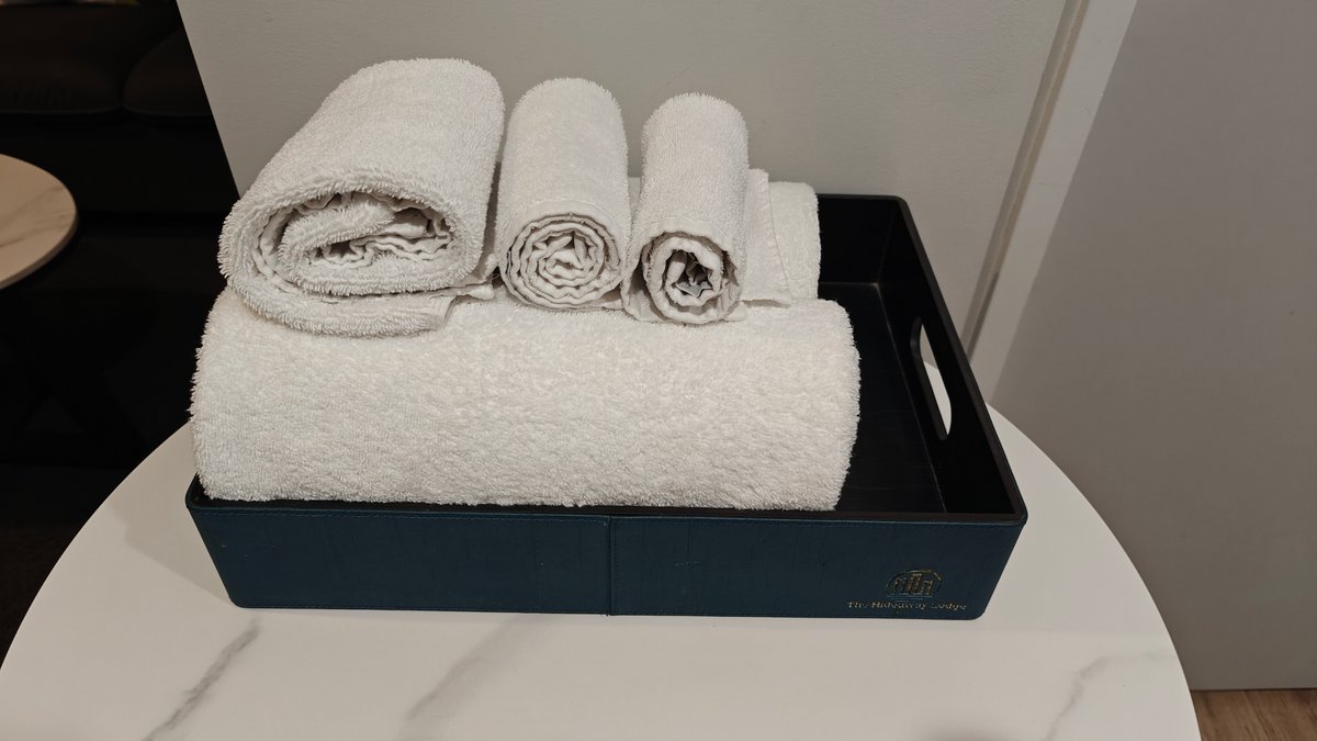 Rolled towels stacked on a tray on the