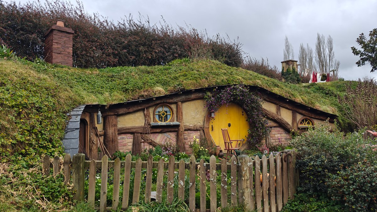 Round yellow door of a hobbit hole