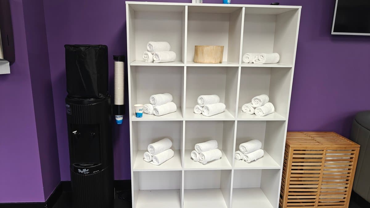 Shelves stacked with rolled gym towels