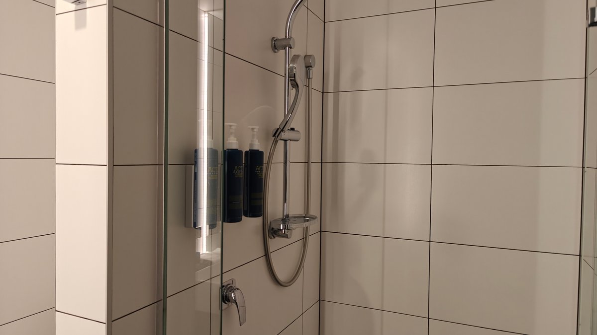 Shower fittings on the tiled wall