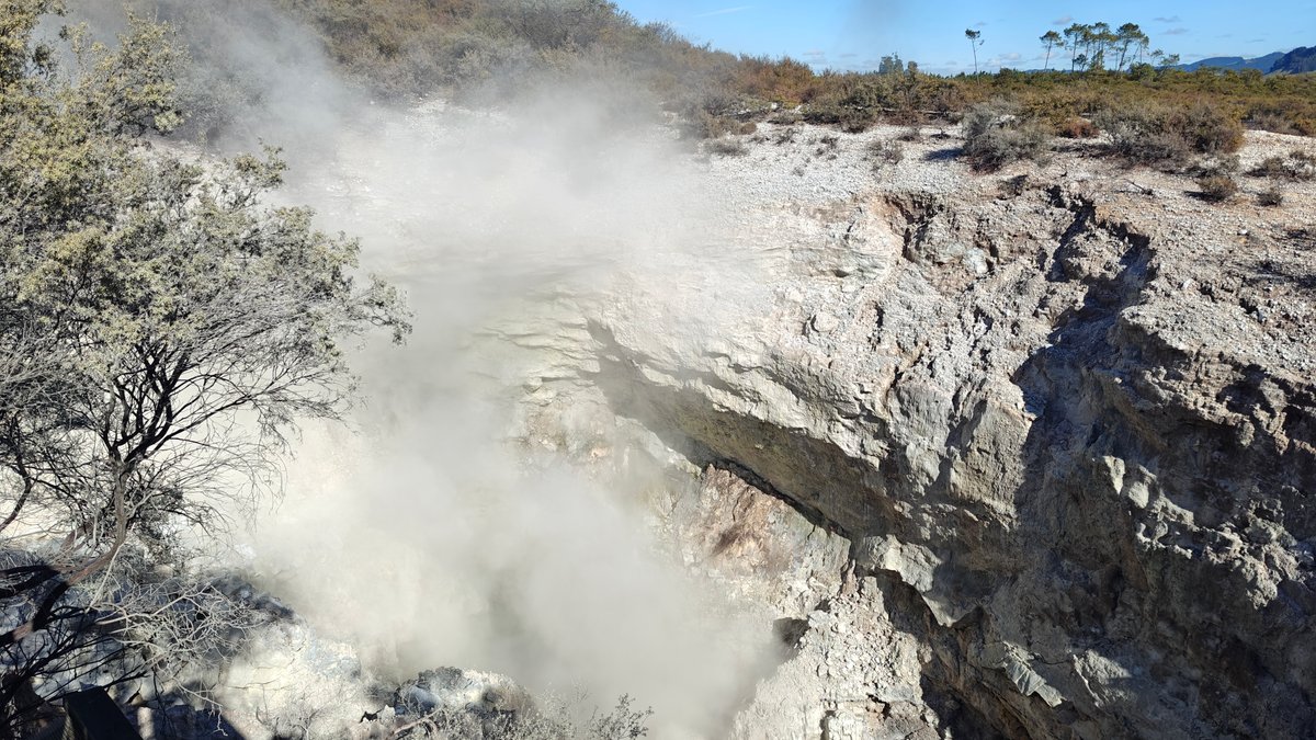 Steam pouring from the crater with scrub around
