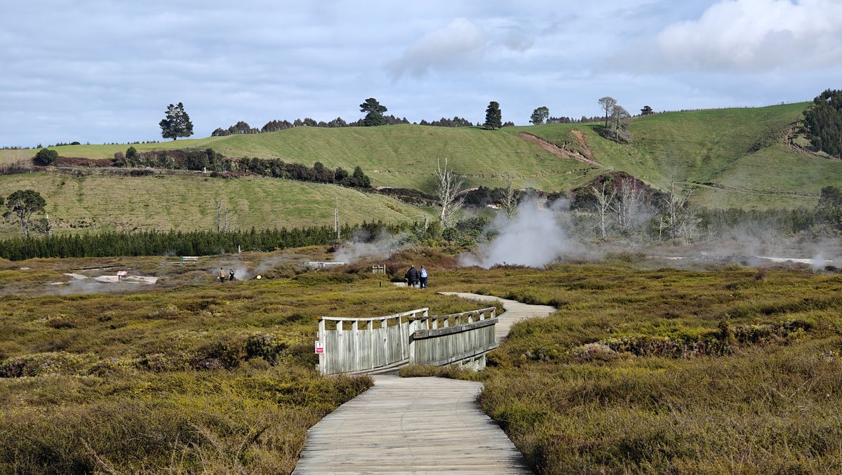 Steam rising toward green farmland