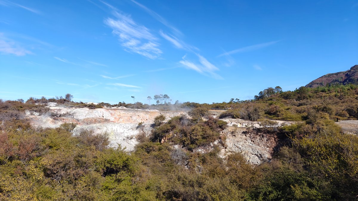 Steaming craters under deep blue sky