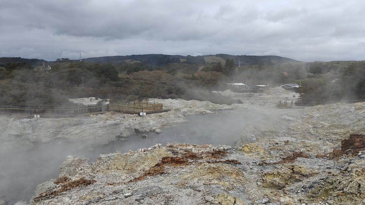 Steaming ground with the hills showing faintly beyond.