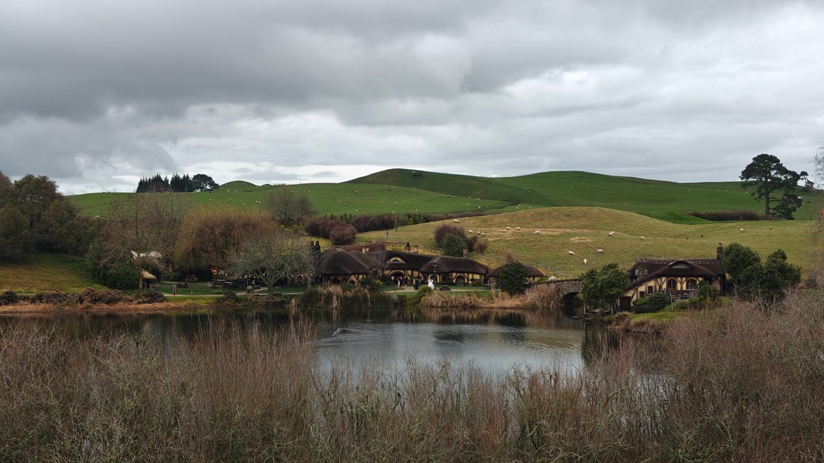 Still lake and rolling green hills