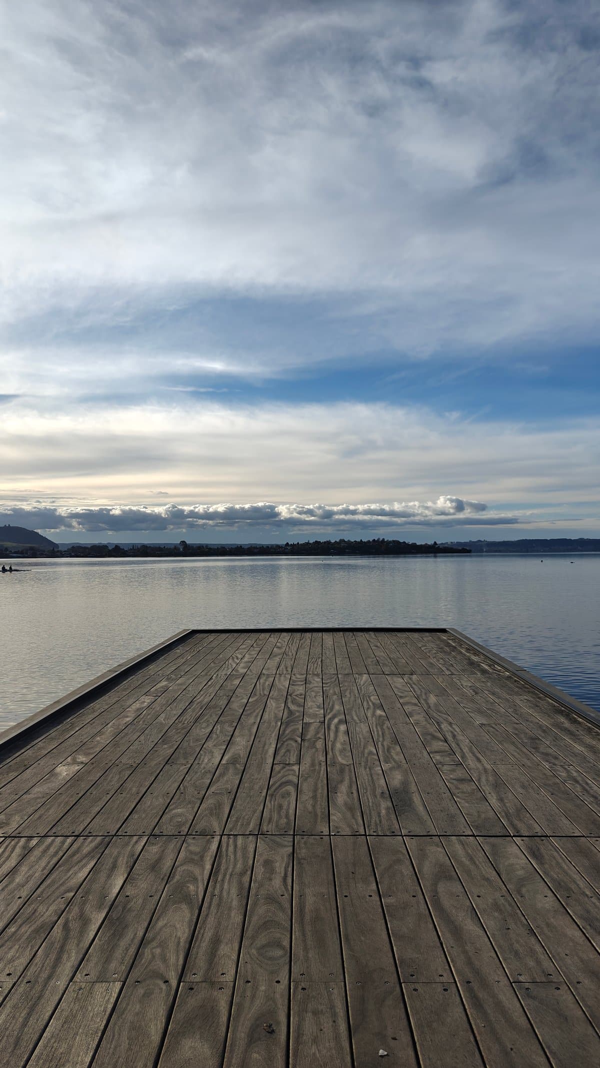 Still water beneath timber jetty
