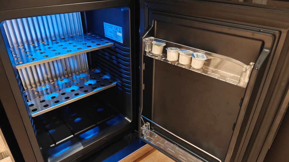 Stocked minibar fridge open