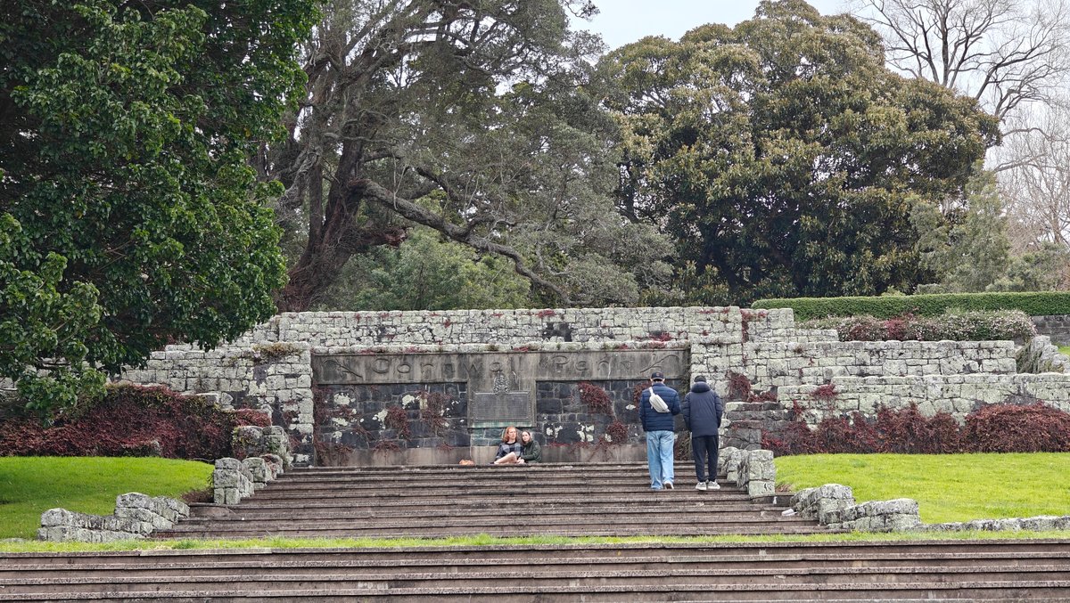 Stone steps and a terrace with visitors, trees