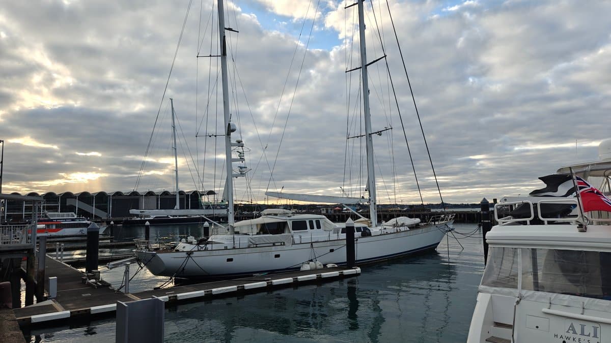 Sunset glow behind yacht masts
