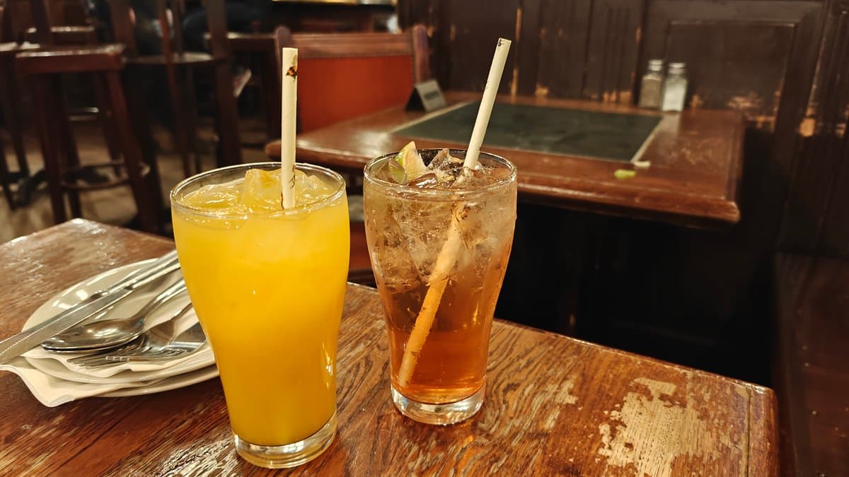 Tall orange drinks on the table