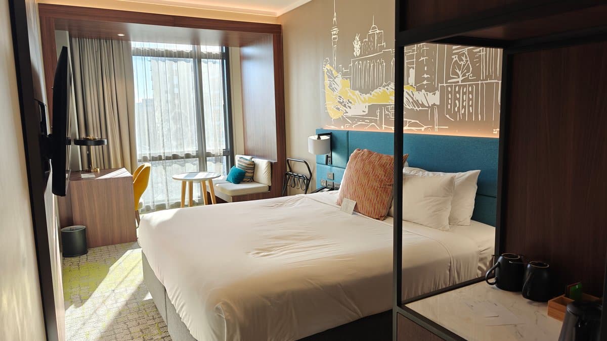 Teal headboard and mirrored wall