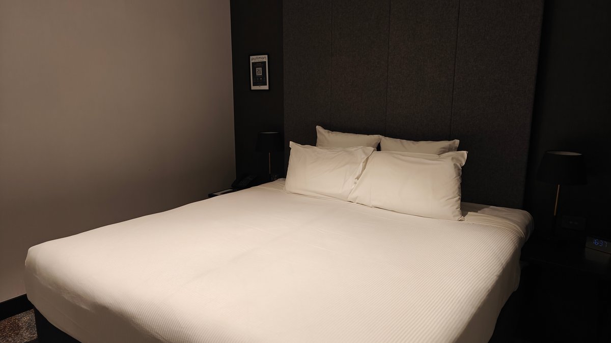 The bed from the foot of the room