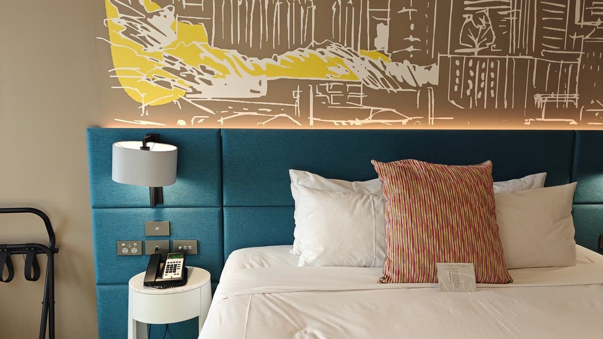 The bedside with the lamp and the made