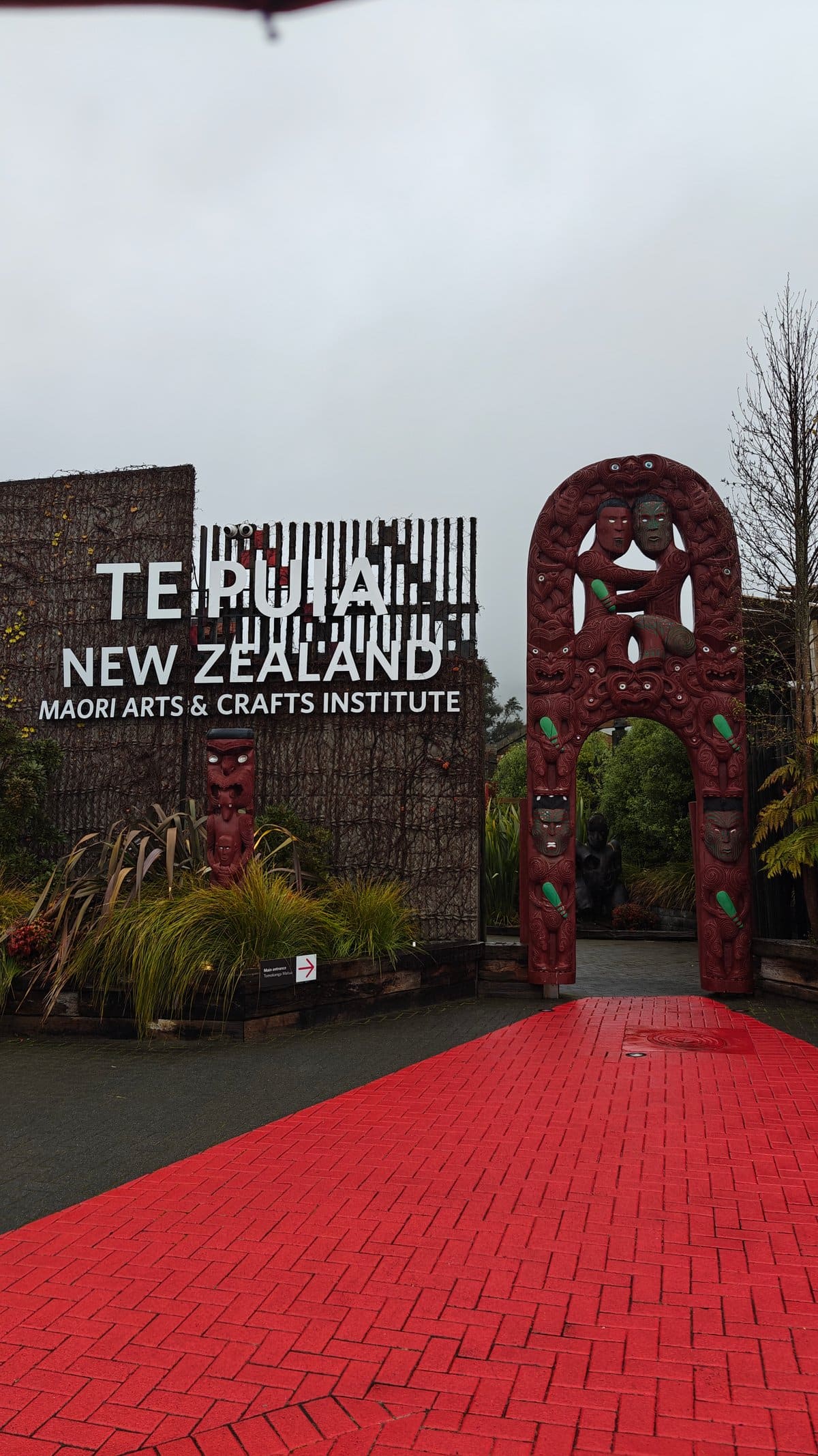 The carved gateway standing over the red brick