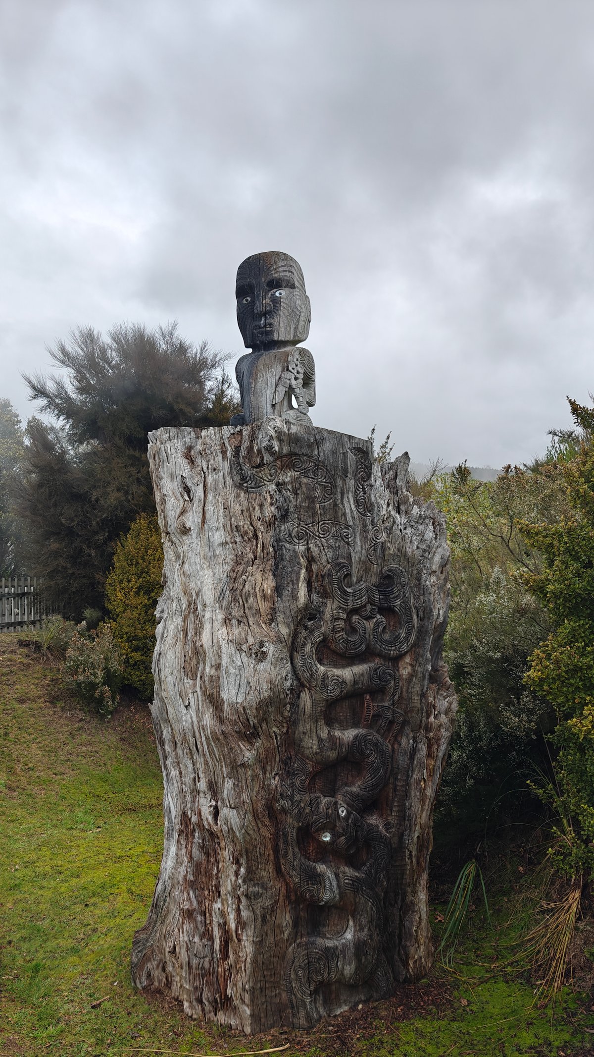 The carved head on its post against the
