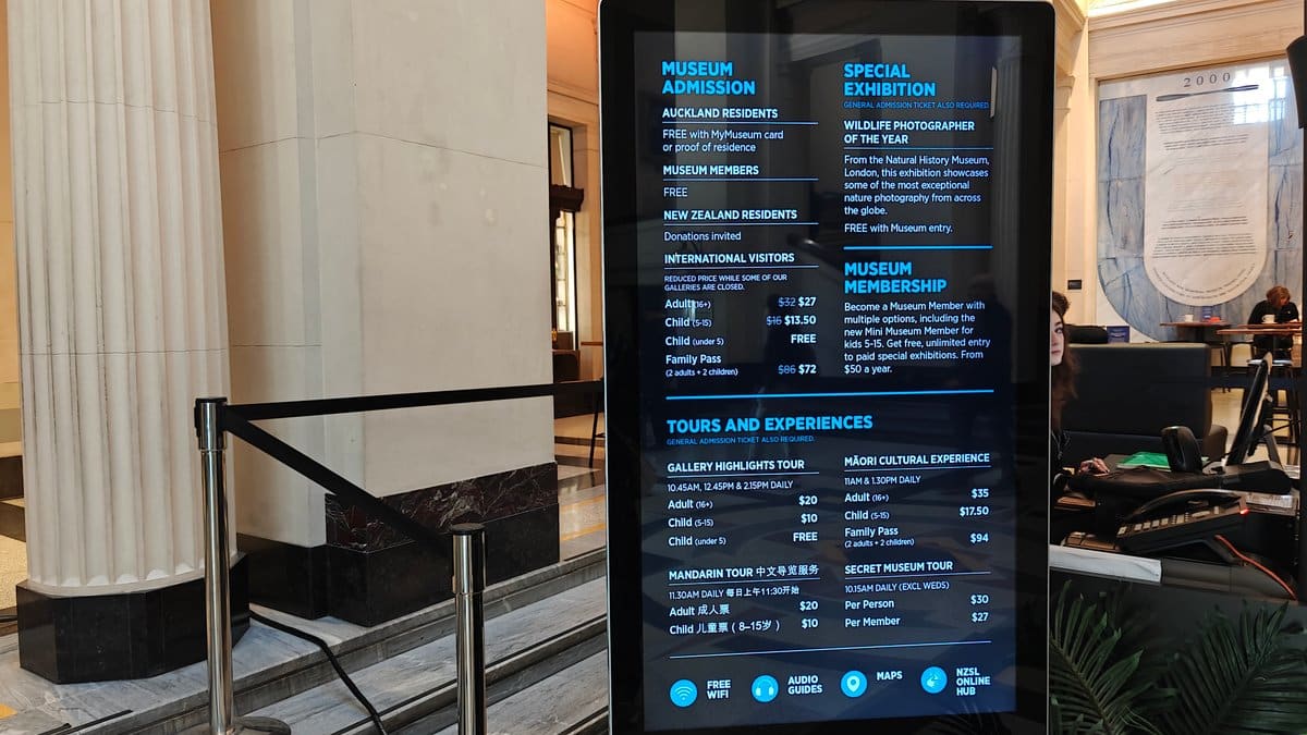 The colonnade with a digital admission board listing