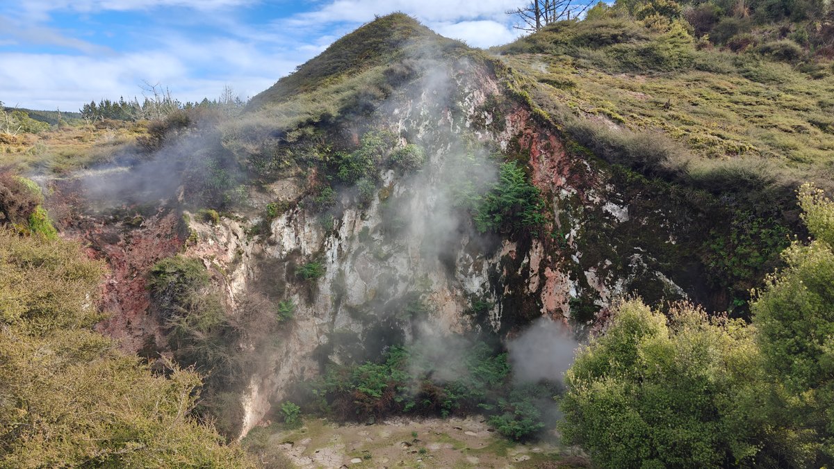 The crater basin with steam lifting across the