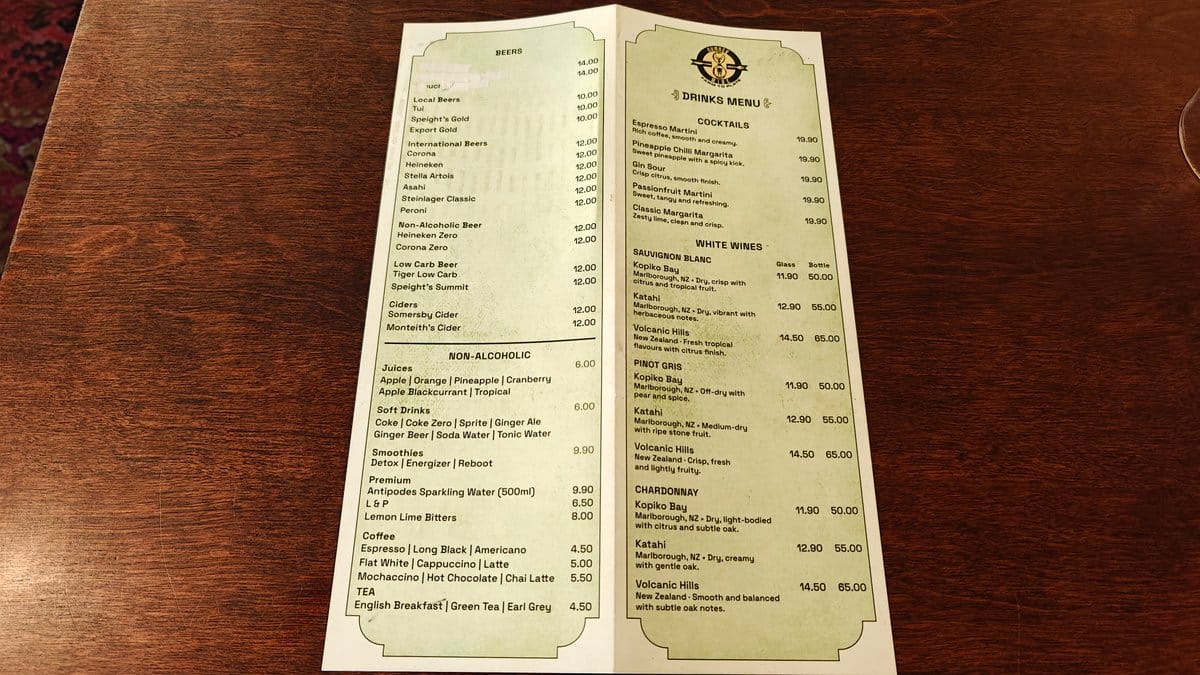 The drinks menu opened flat on the dark