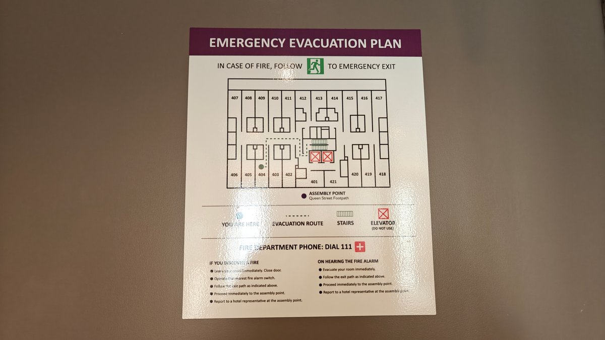 The emergency evacuation plan mounted inside the room
