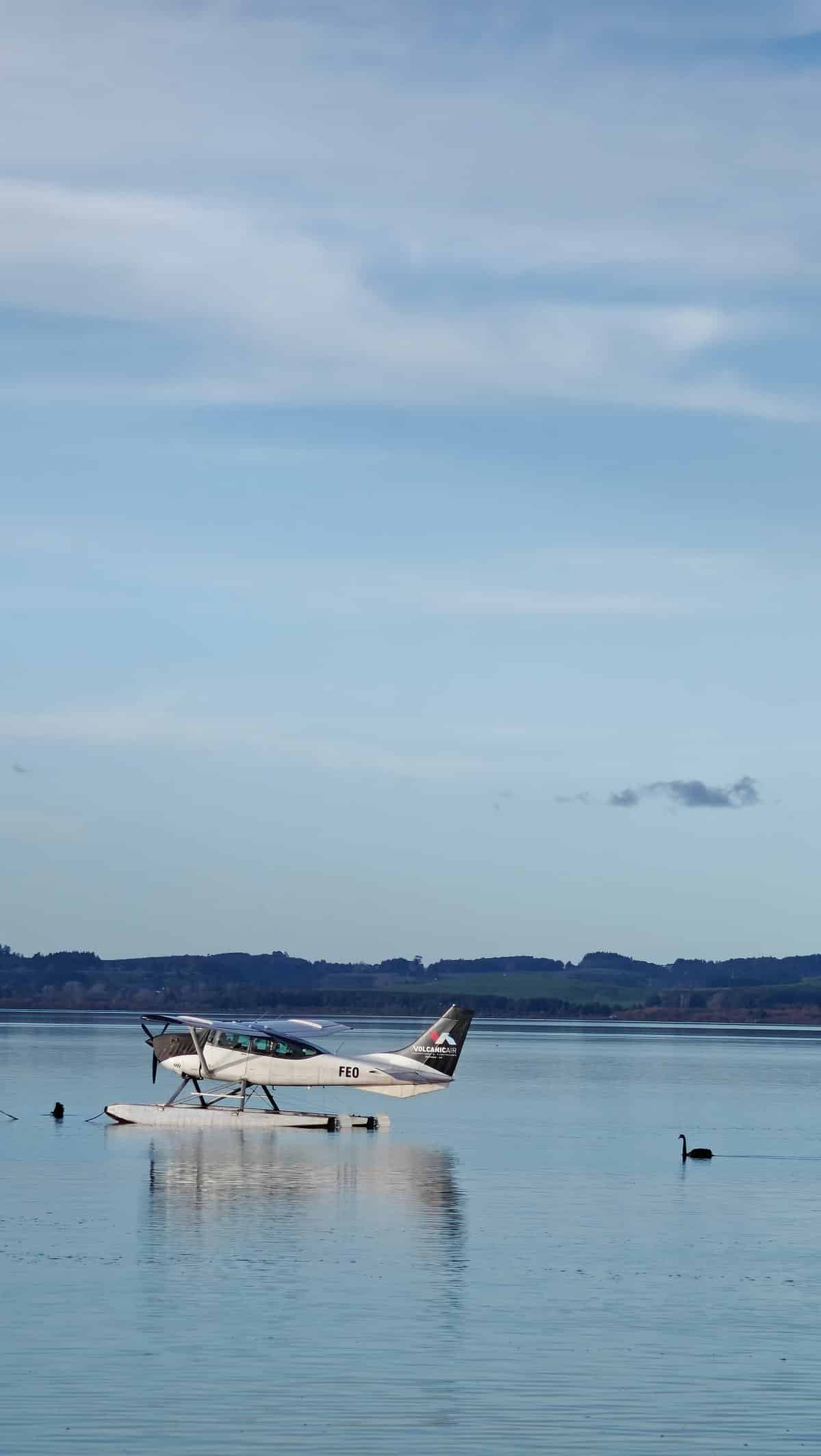 The floatplane taxiing across the flat water.