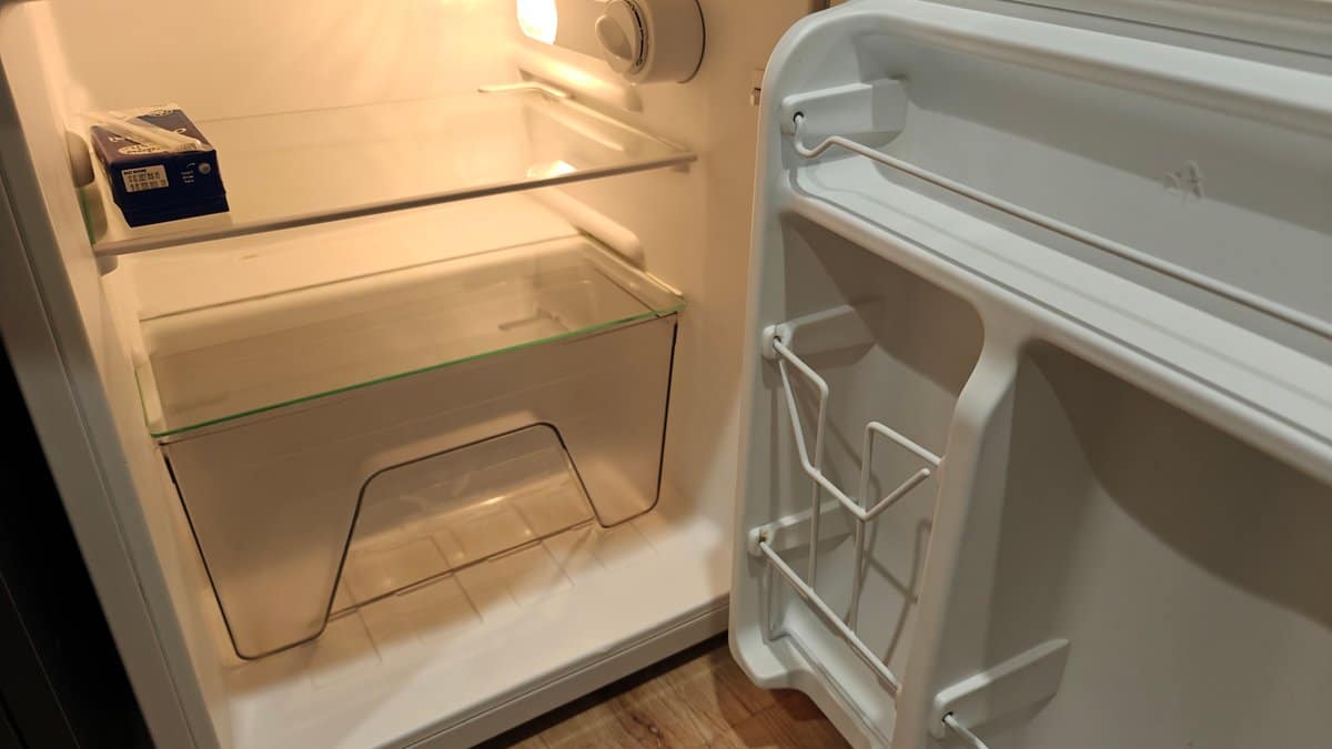 The fridge interior with its empty shelves and