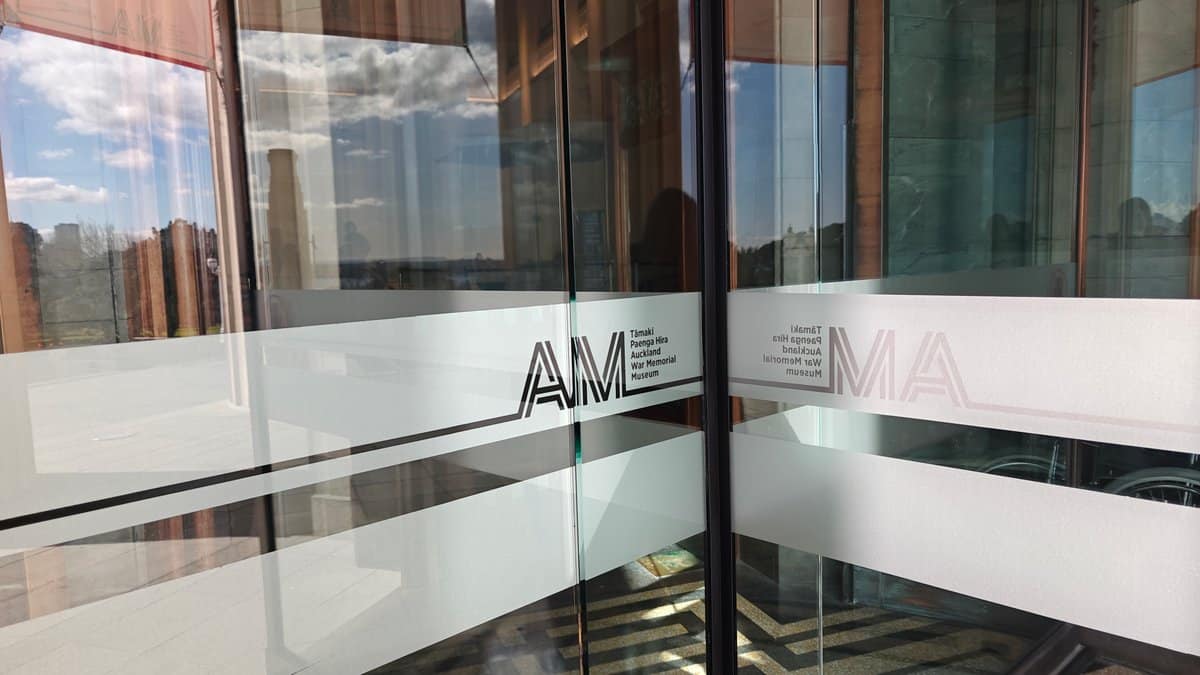 The glazed atrium wall etched with the AM