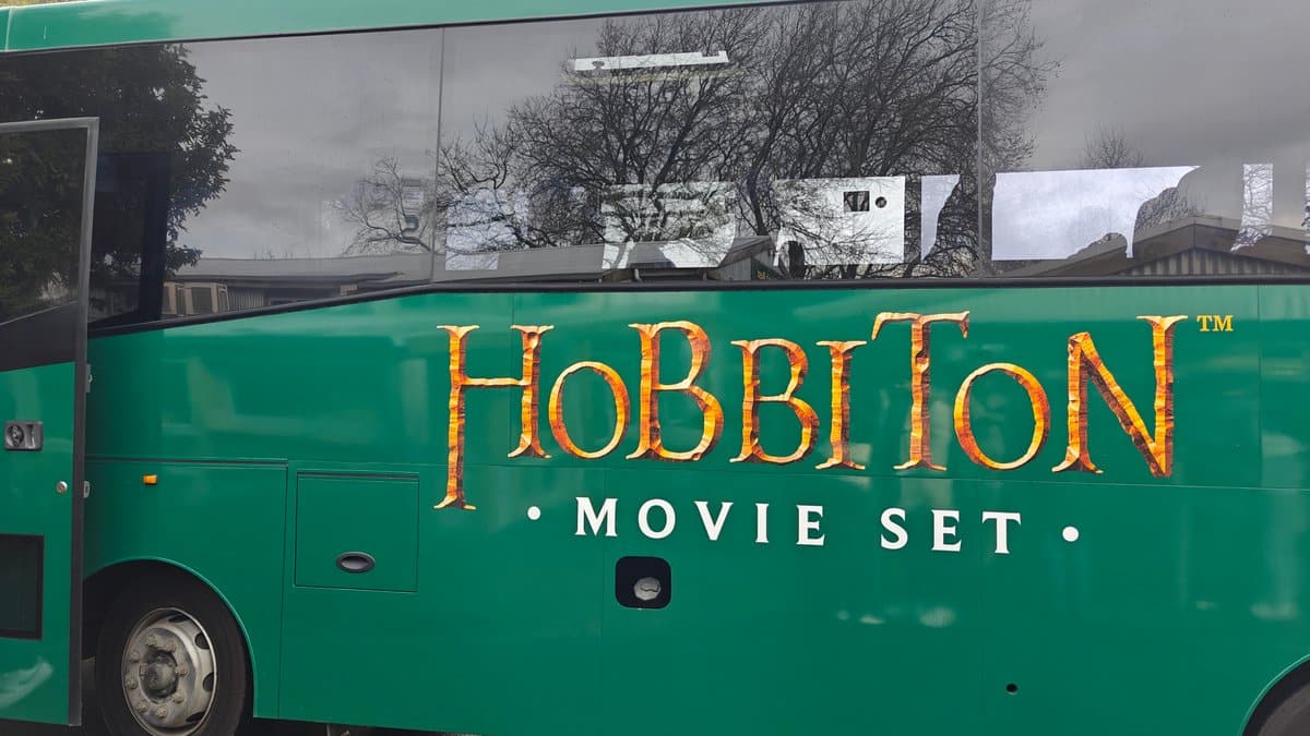 The green HOBBITON MOVIE SET bus waiting to