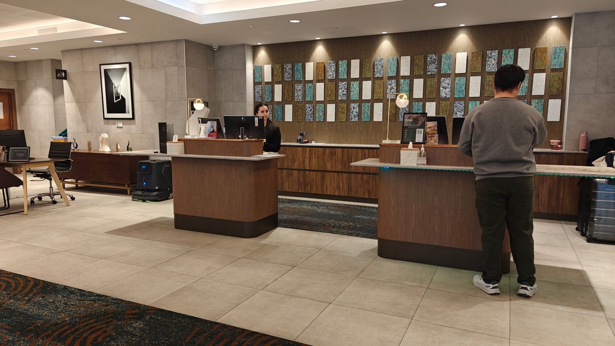The hotel reception desk with a guest checking