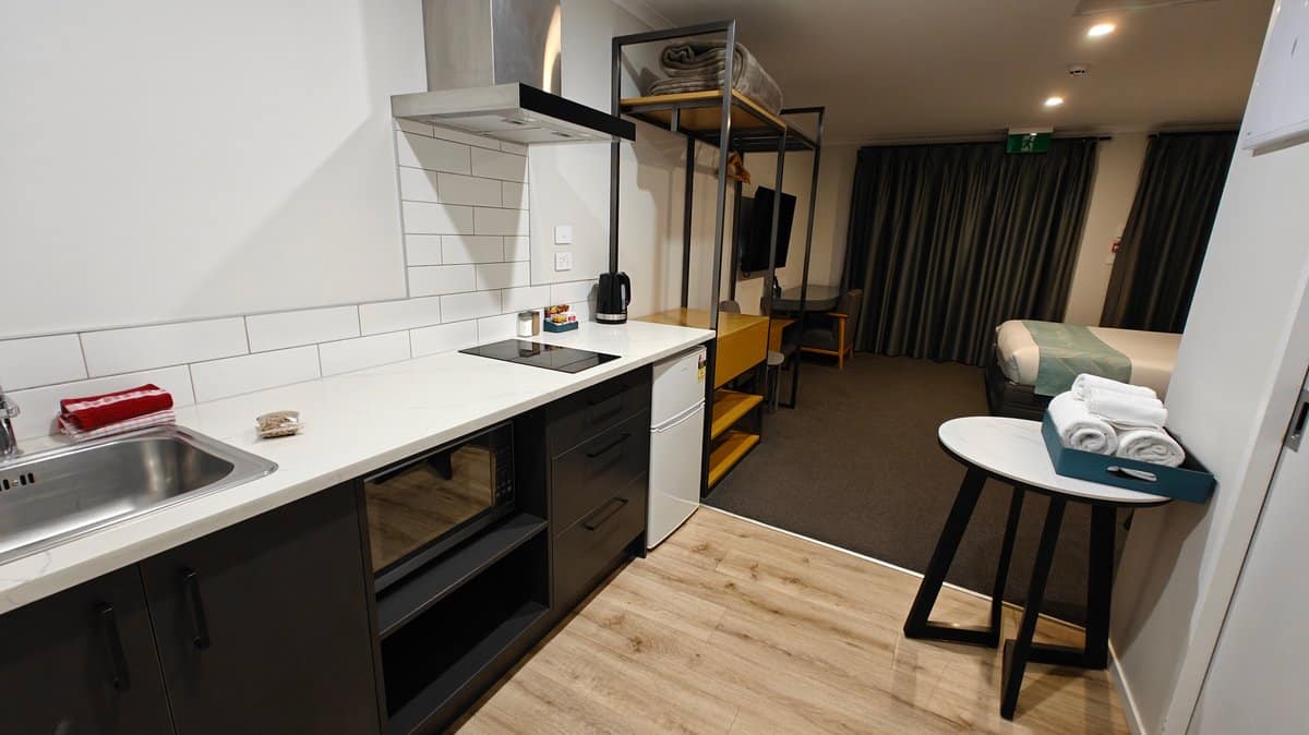 The kitchenette with the bed beyond it in