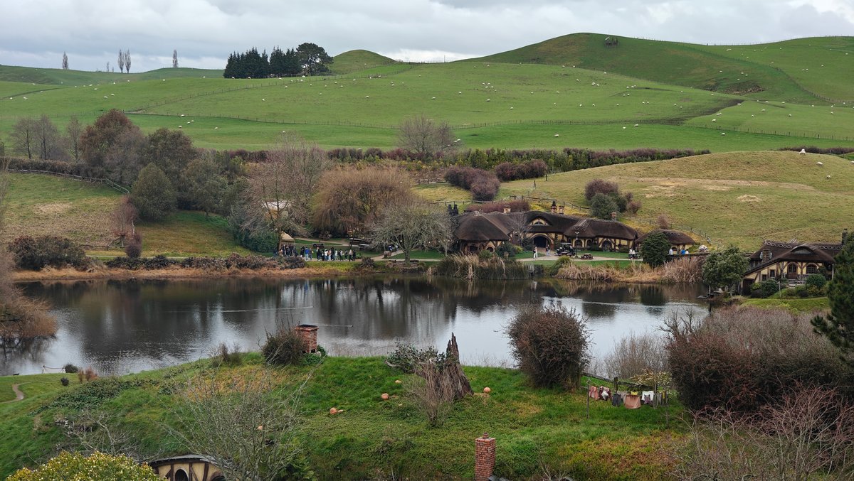 The lake with the rolling green hills rising