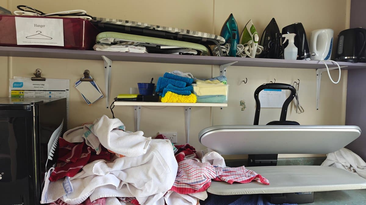 The laundry bench with irons, boards and folded