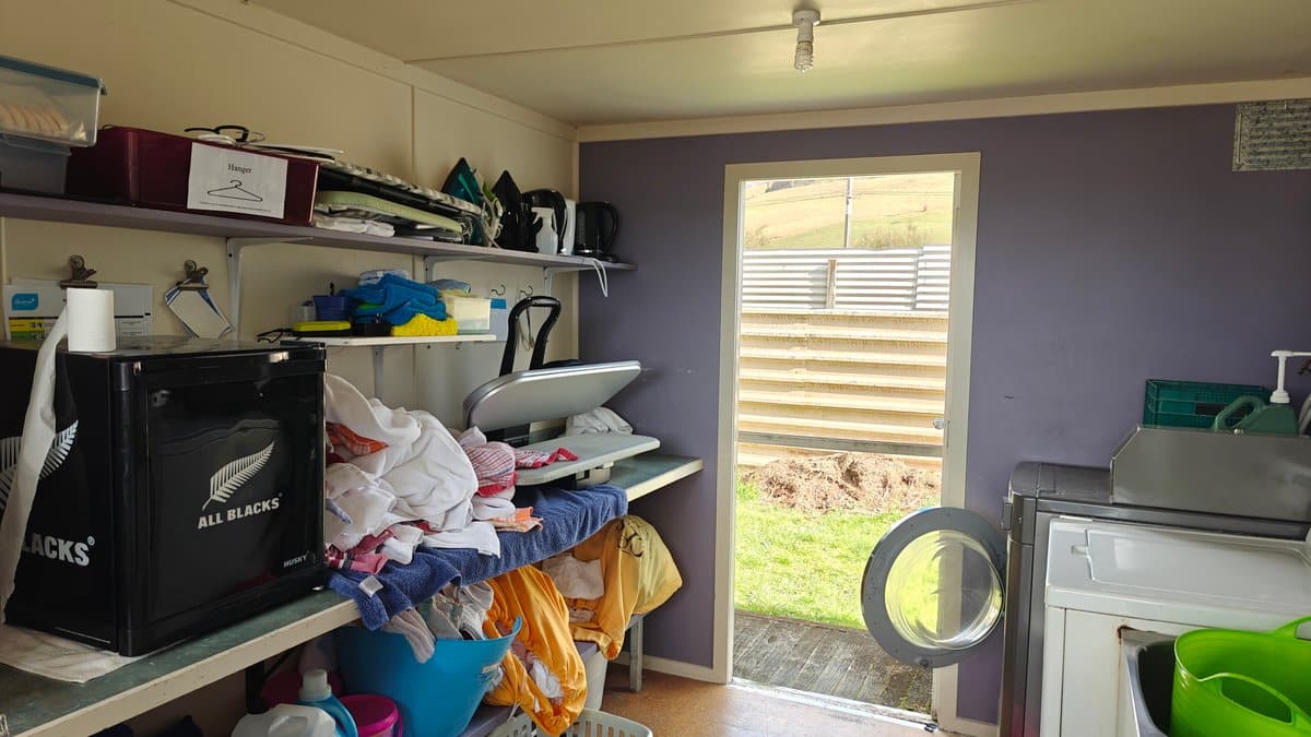 The laundry interior with shelving, a machine and