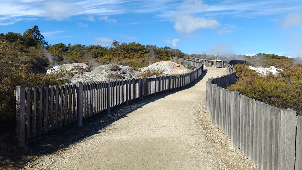 The path running between the fences across the