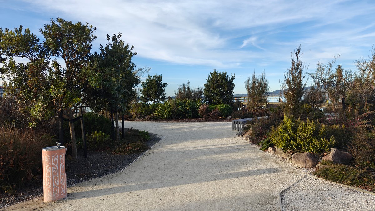The path with planting and a carved marker