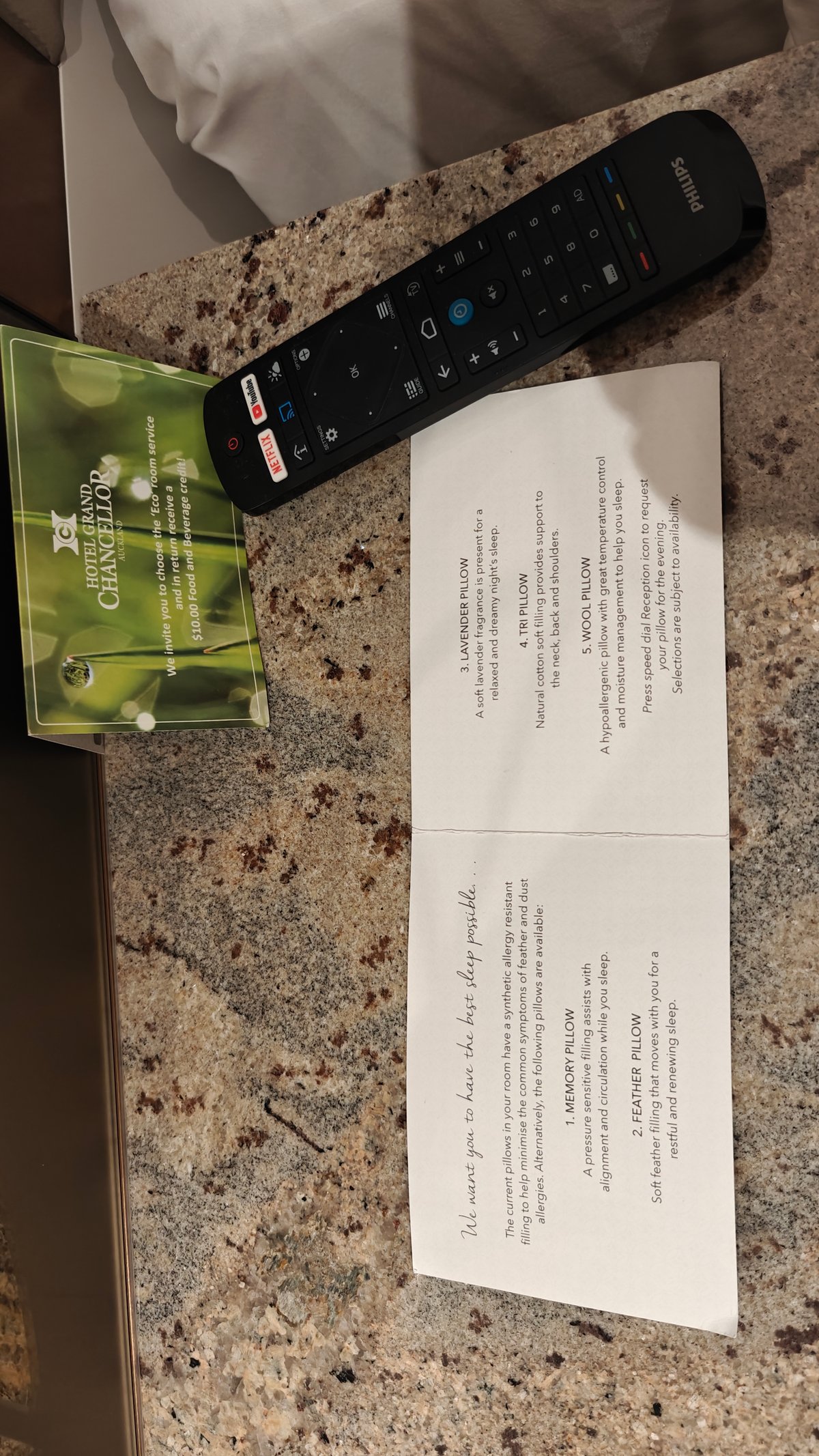 The remote and a folded information card on