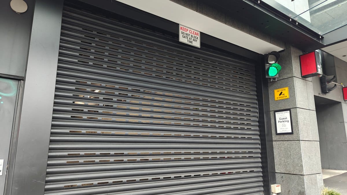 The roller shutter closed across the car park