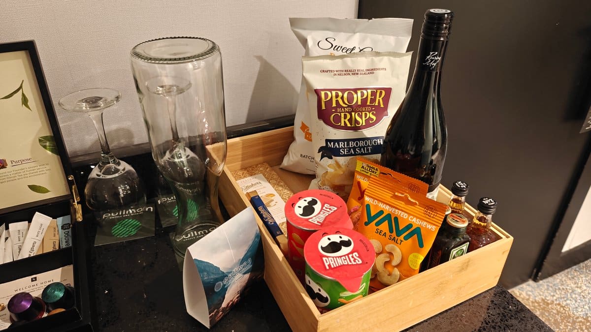 The snack tray with crisps and a bottle