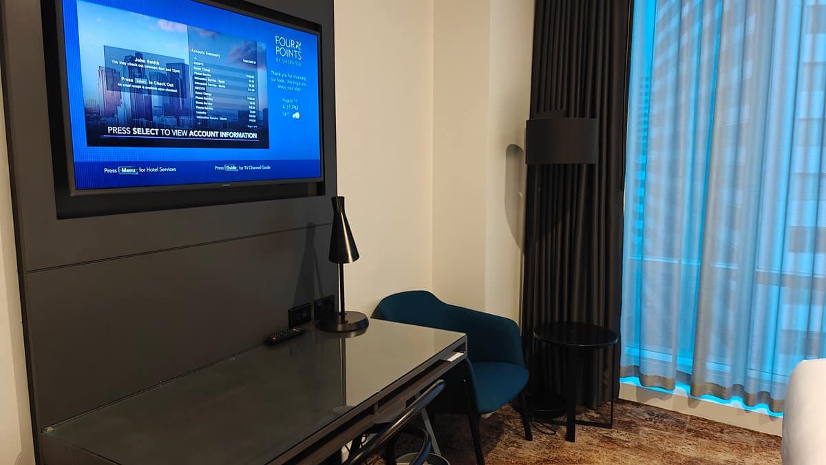 The television mounted on the wall opposite the