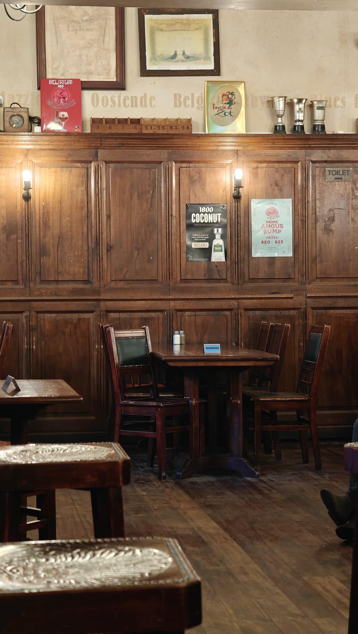 Timber booth against panelled wall