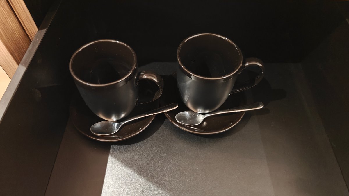 Two cups and saucers with spoons set on