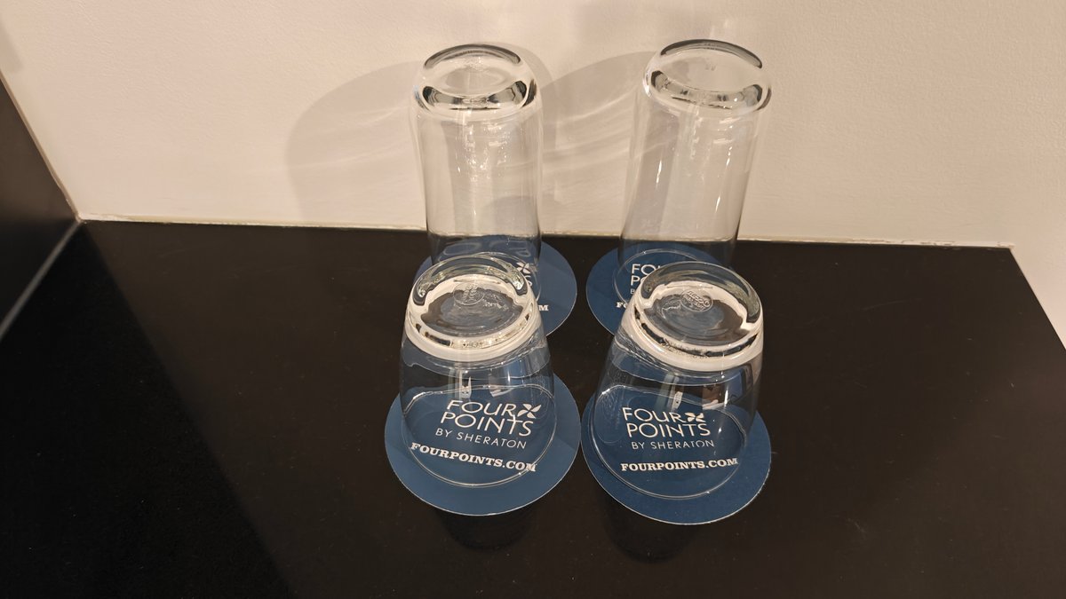 Two glasses set upside down on a tray.