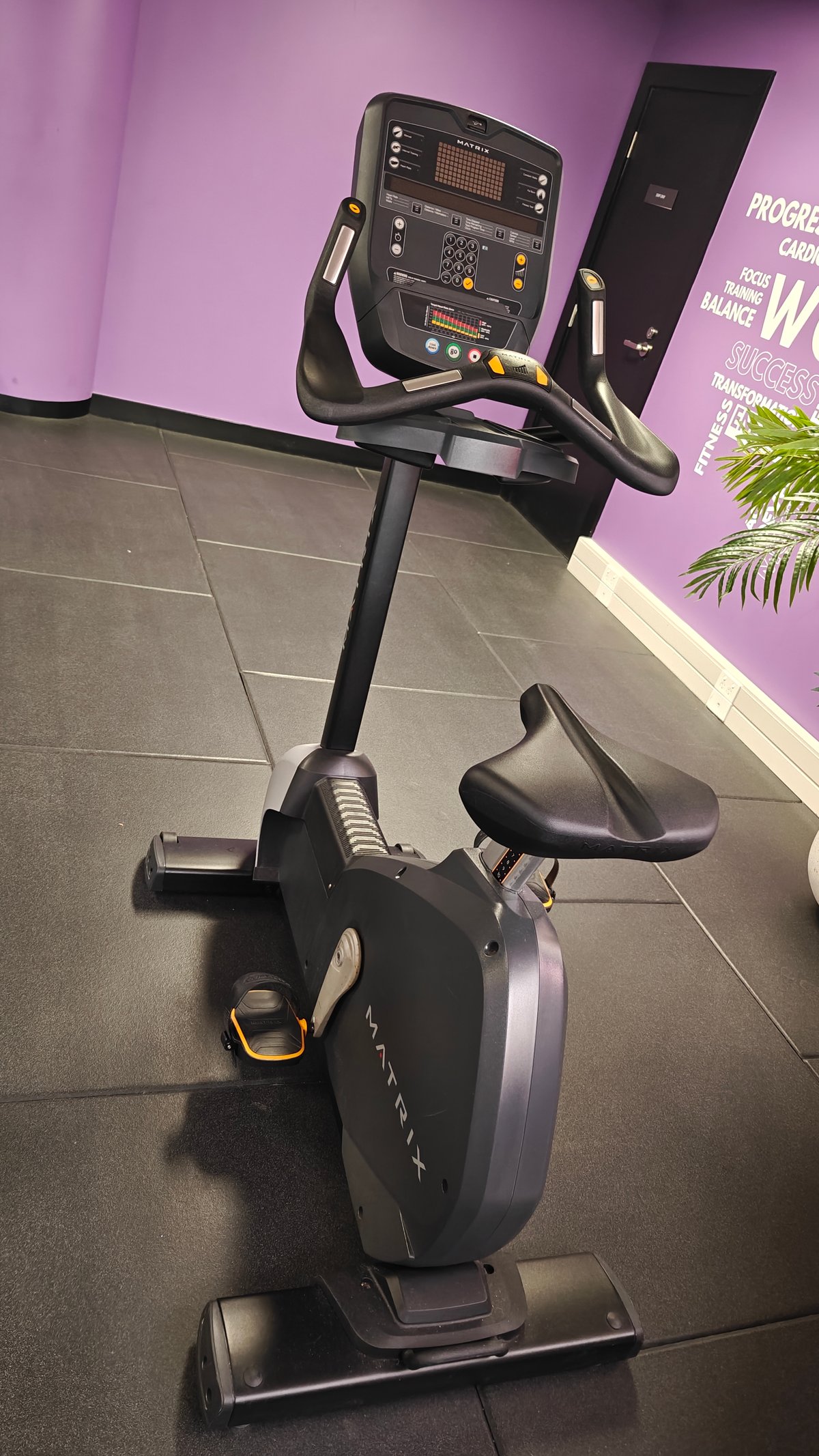 Upright exercise bike on tiled floor