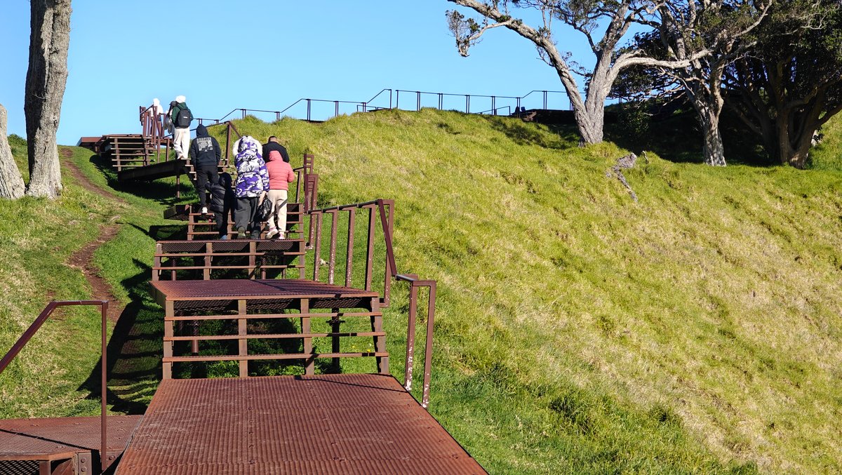 Visitors descending the summit steps