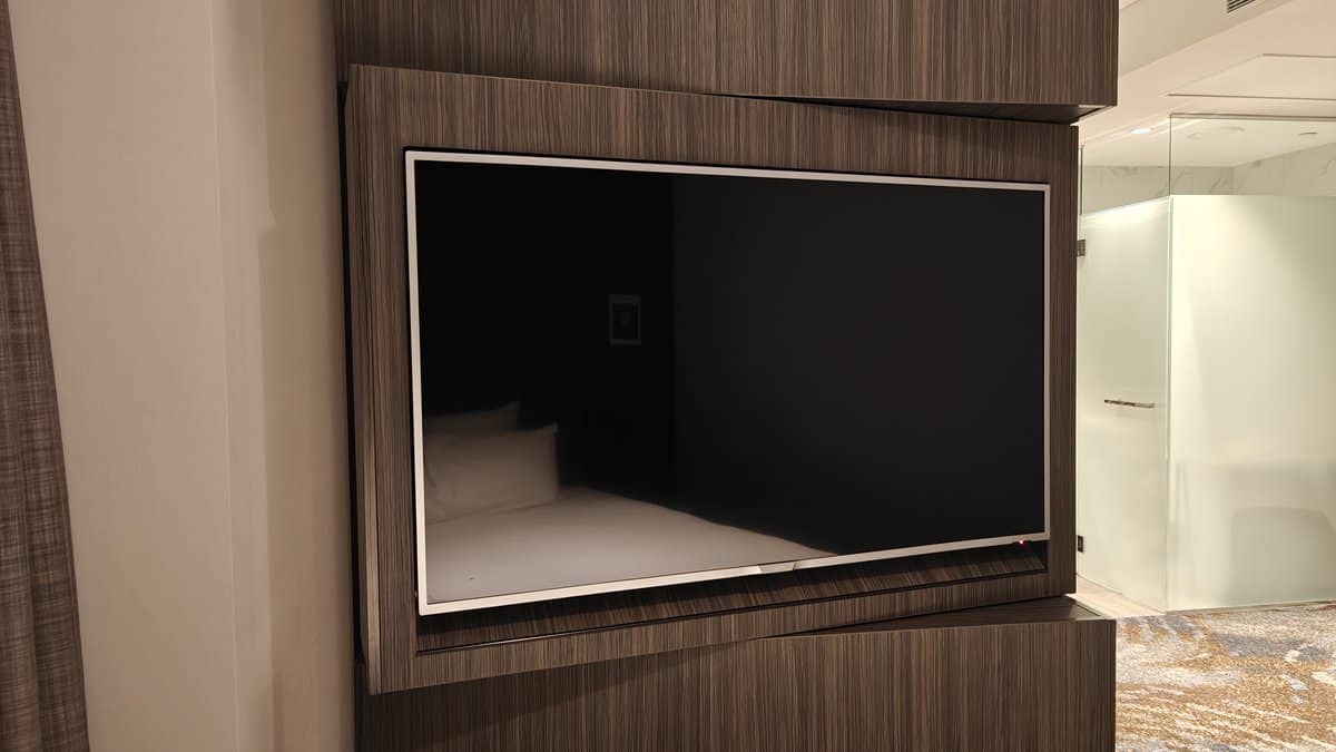 Wall-mounted television on timber panel